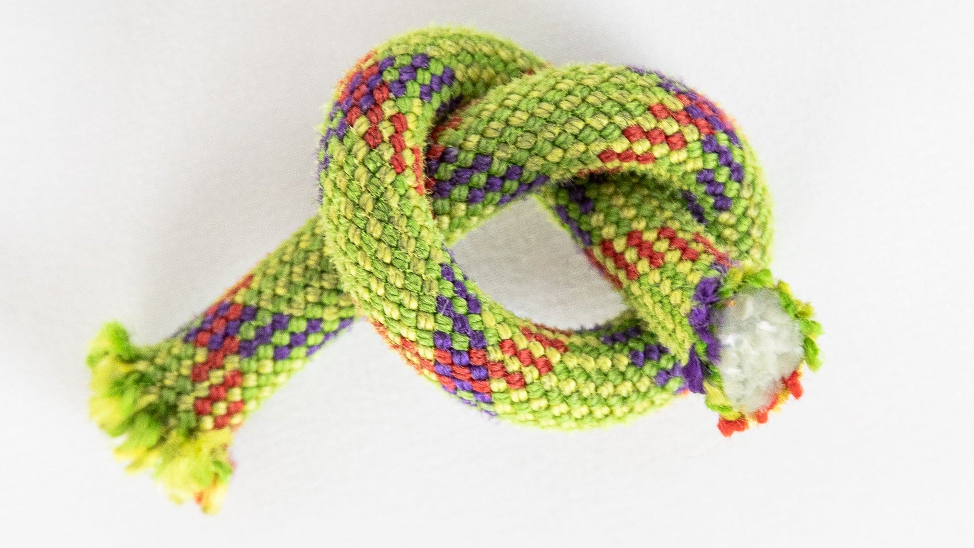 yellow/green climbing rope on a white background