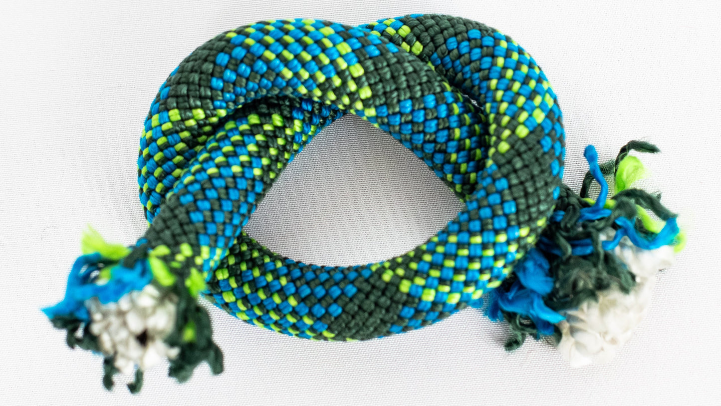 Colourful braided rope with decorative elements on a white background