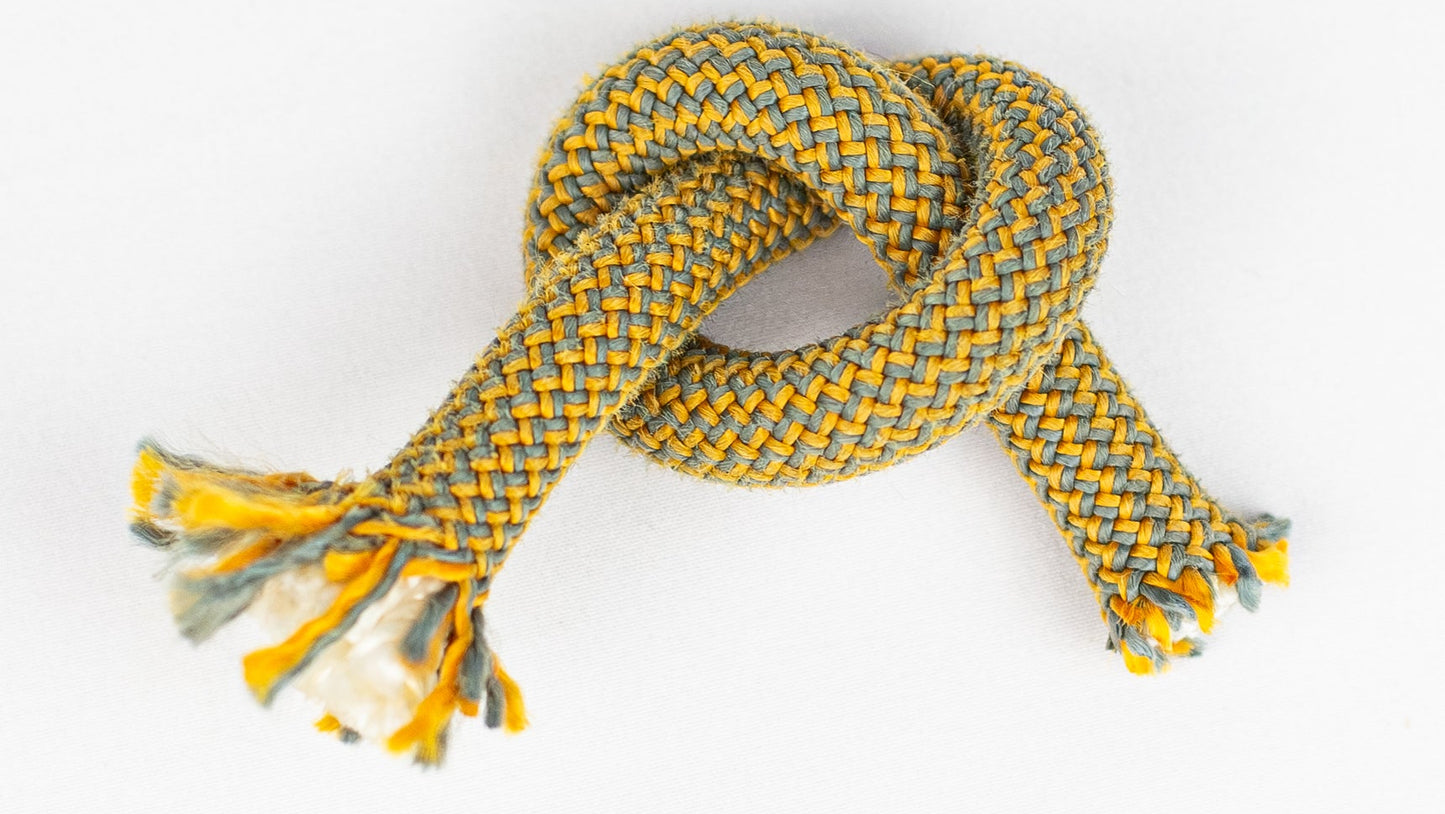 Yellow and grey knotted rope on a white background