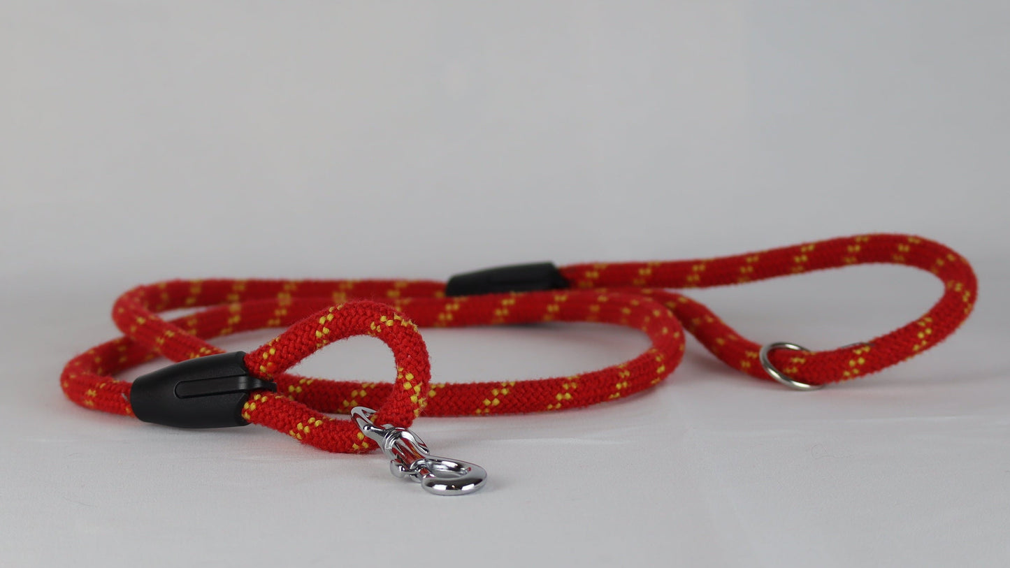 Red dog leash with a silver clasp on a white background